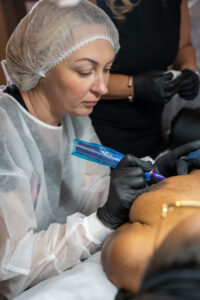 Dr. Cecilia Rusnak Master Trainer teaching scar camouflage techniques for dark skin tones at Dr. Rusnak Academy paramedical tattoo training