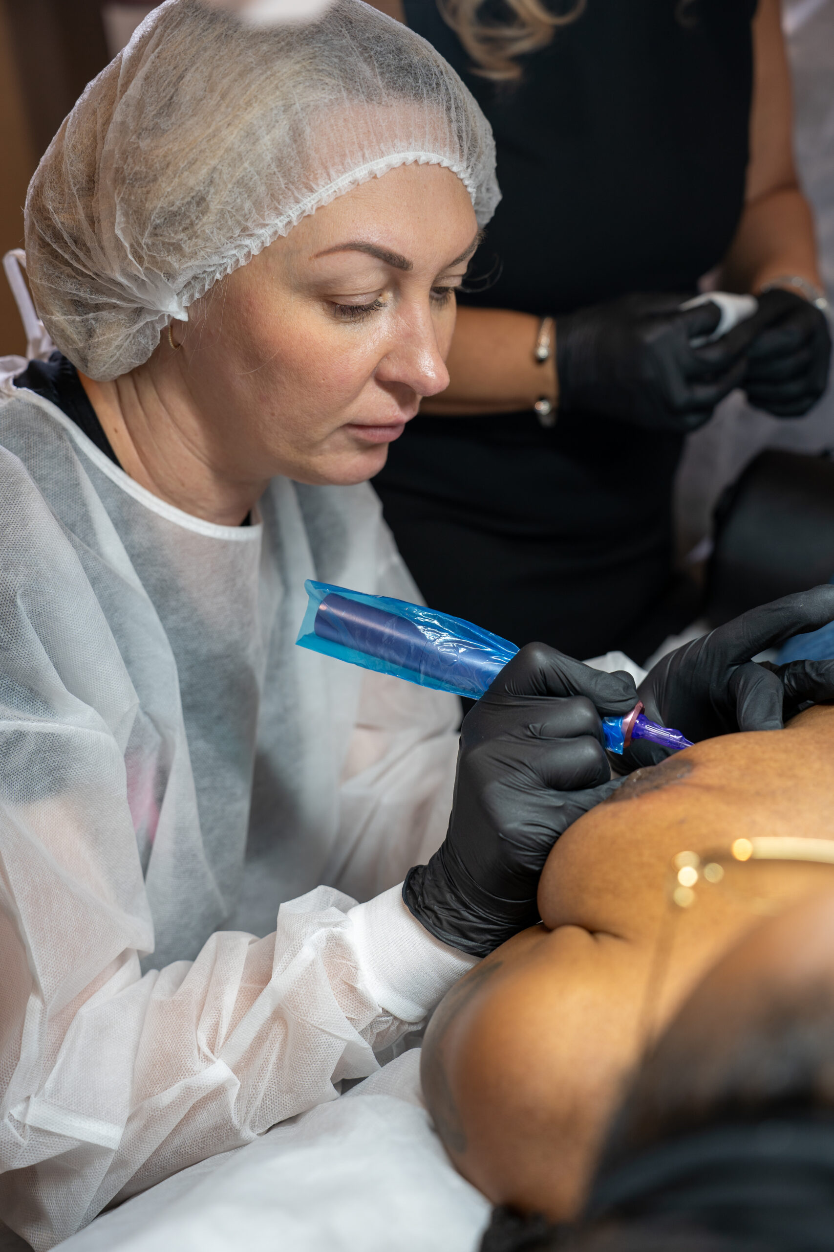 Paramedical tattoo pigment theory in practice — matching custom-blended pigment to melanin-rich skin tones at Dr. Rusnak Academy